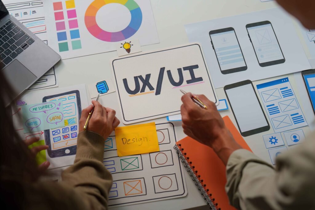 UI/UX design workspace with wireframes and mobile screens